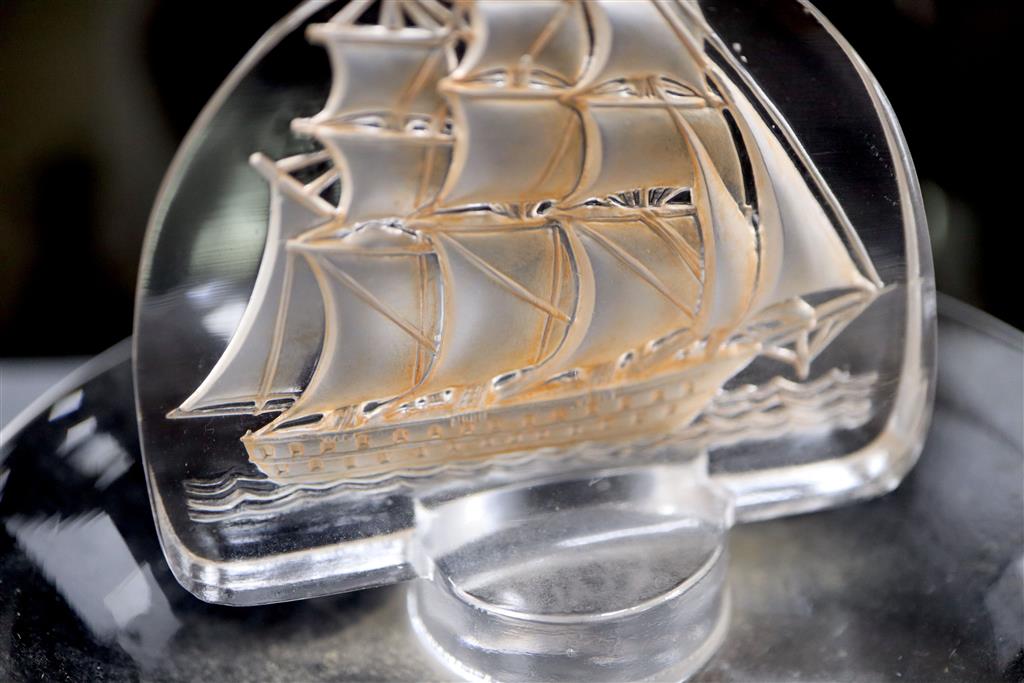 René Lalique. A pre-war amber tinted glass Caravelle pattern cendrier, no.312, designed in 1930, 10cm diameter